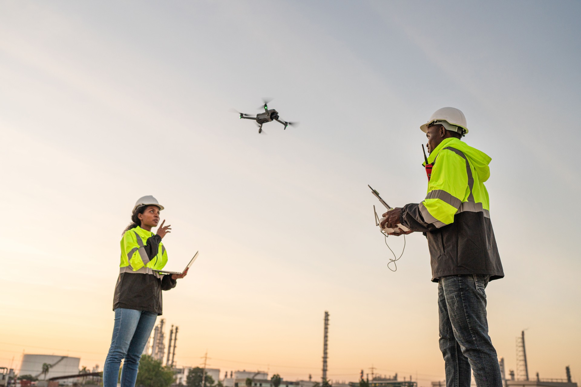 Team of Engineer Specialists Pilot Drone on Construction Site.